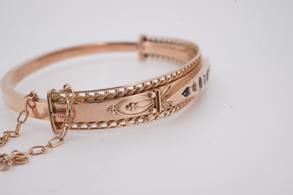 An Edwardian 9ct gold, sapphire and diamond set hinged bangle, Chester, 1909, interior diameter 57mm, gross weight 10 grams. Condition - poor